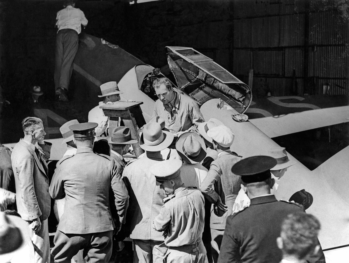  Scott and Campbell Black checking the fuel levels of their DH.88 at Charleville  (State Library QLD) 