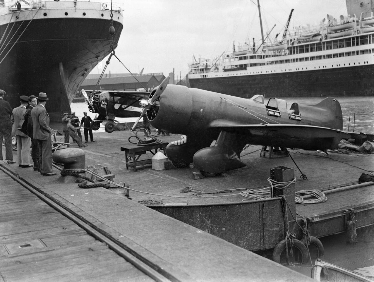  Lambert Monocoupe D-145 (NR501W) 'Baby-Ruth' and Jacqueline Cochran's Granville Gee Bee R-6H 'Q.E.D' being unloaded at Southampton 