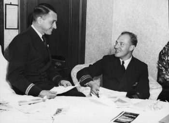  KLM pilots Jan Moll and Koene Parmentier reading congratulatory telegrams at the Menzies Hotel, Melbourne (State Library VIC) 